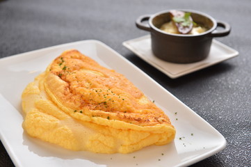 Fried egg on white plate on the table in restaurant