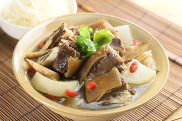 Mixed soup of beef and radish on chinese bowl on bamboo tray