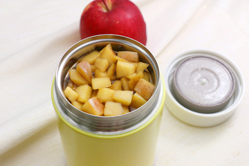 Stew pot of cube apple soup on the table