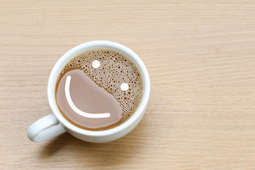hot coffee in a white Coffee cup on wooden table.
