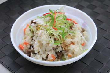 Special fried rice with pork and herbs on white bowl on the tabl