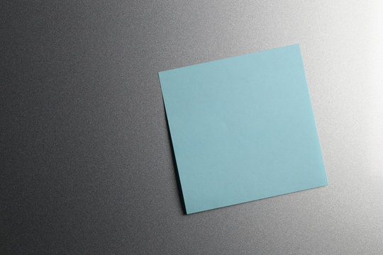 Empty blue paper sheet on refrigerator door.
