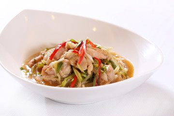 Special chicken salad with onion, chili and herbs on white bowl