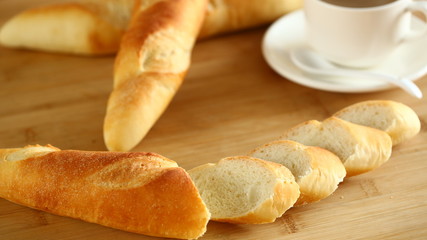 Chopped long bread on wooden cutting board