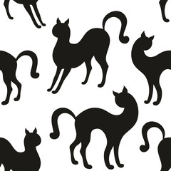 Vector seamless pattern with the image of the silhouettes of beautiful graceful cats