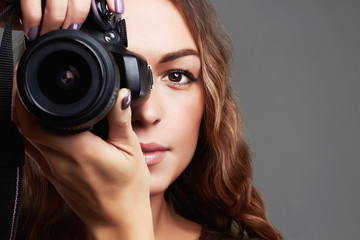 beautiful girl with camera.Pretty woman is a professional photographer - obrazy, fototapety, plakaty