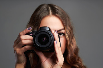 beautiful girl with camera.Pretty woman is a professional photographer