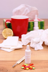 Pills and nose drops for colds, used handkerchiefs and hot tea with lemon