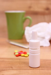 Pills and nose drops for colds, used handkerchiefs and hot tea