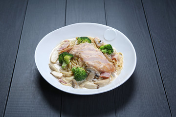 Chicken Carbonara with green broccoli and mushroom on white plat
