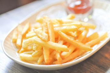 French fries  and ketchup dip in soft focus