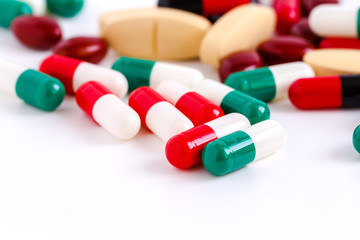 Pills and capsules on white background