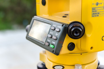 Closeup theodolite outdoors at construction road  Selective focus.