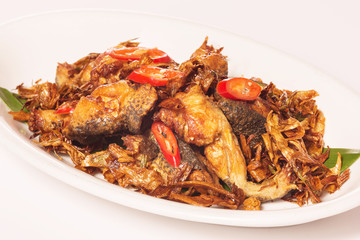Fried frogs in Taiwanese style with chili and herbs on white pla