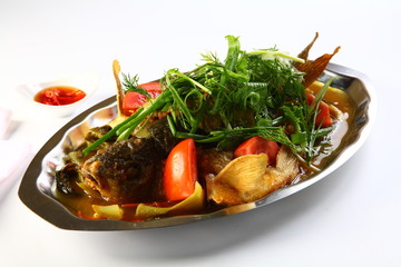 Steamed barramundi fish with onion and herbs in Hong Kong style