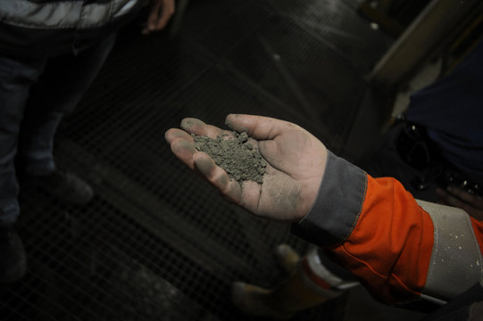 Miner hand holding a raw material