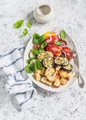 Roasted eggplant panzanella on a light background, top view.