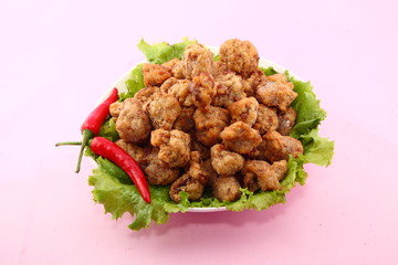 Crisp pork ribs with lettuce and chili on white background