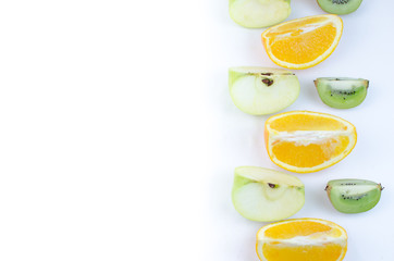 Fototapeta na wymiar Fruits orange, apple, kiwi, sliced on a white background.