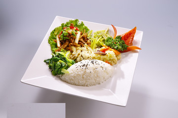 Scallions Pork rice with vegetable on white plate in white backg
