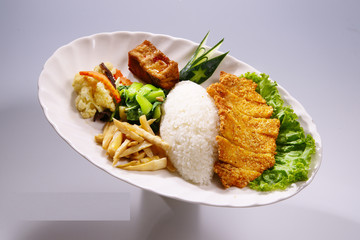 Crispy Chicken Rice with vegetable on white plate in white backg