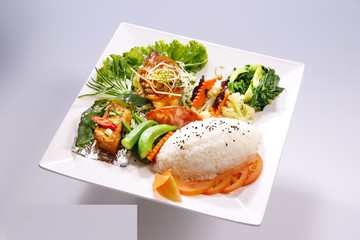 Braised pork rice, braised fish meal with vegetable on white pla