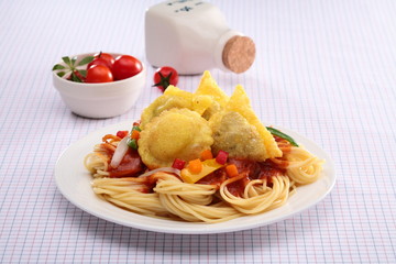 Spaghetti Ravioli with fried wonton and tomato on white plate