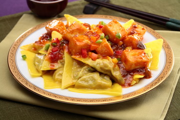 Chinese-style ravioli with fried tofu on white plate