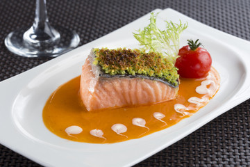 Baked Salmon filled with herbs in Lobster sauce and tomato, lett