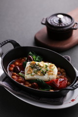 Steamed Atlantic cod saffron braised with bean on black stew