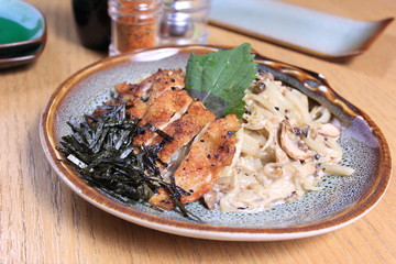 Fried chicken with mushroom and seaweed on plate