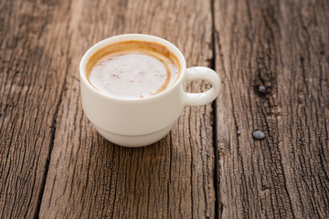 coffee cup on old wooden table,Cappuccino coffee in a white cup