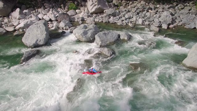 Aerial Shot of Guy in Kayak Paddling Rapids in River Current