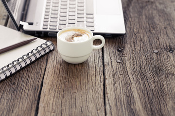Cup of coffee on a wooden table.