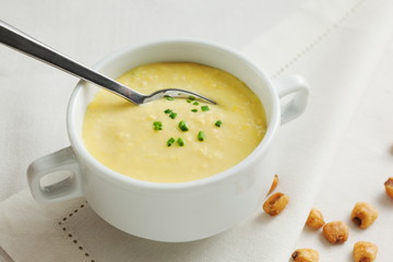 Corn soup with cream and dried lotus beans on white background