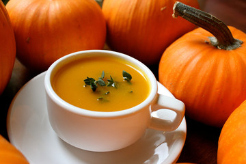 Pumpkin soup with potatoes and chestnuts in white cup