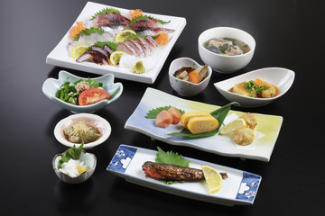 Traditional japanese meal with sushi, radish, seafood and soup