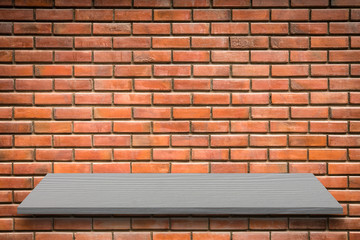 Empty top of natural stone shelves and old brick wall background