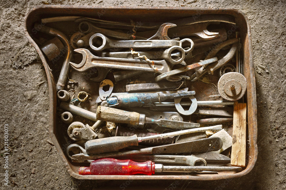 Wall mural old vintage rusty metal box with wrenches, screwdrivers and other tools mechanics. contrast light. v