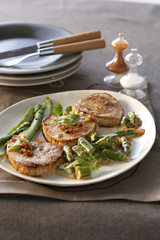 Fried veal with asparagus granada  on white plate