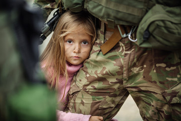 Soldier and children on battlefield background.
