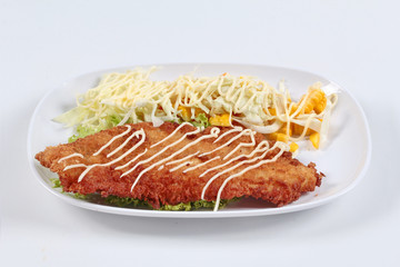 Dolly's Fish Fry with mixed vegetable salad on white background. Side view.
