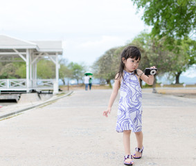 Young little girl shooting camera