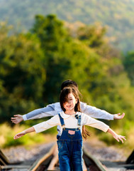 Boy and girl walk on the railway