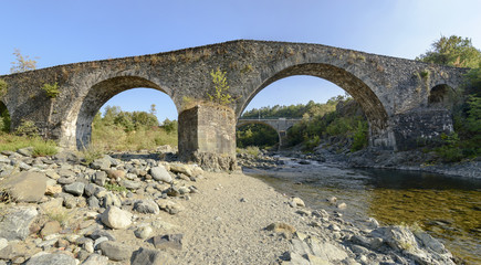 Fototapeta na wymiar medieval bridge near santa Maria alla Croce abbey, Tiglieto, Ita