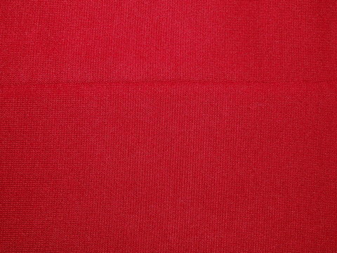 текстура насыщенный красной ткани из хлопка со швом по середине   