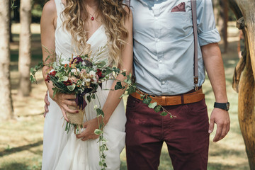 Bride with a wedding bouquet and the groom. Vintage/Bohemian/Rustic wedding - obrazy, fototapety, plakaty