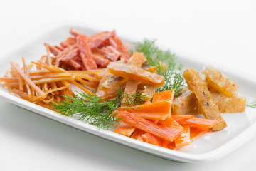 Fried fish platz with cumin and herbs on white plate