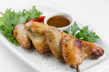 Fried chicken wings with spicy soy sauce on white plate