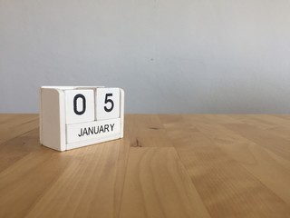 January 5th.January 5 white wooden calendar on wood background.C